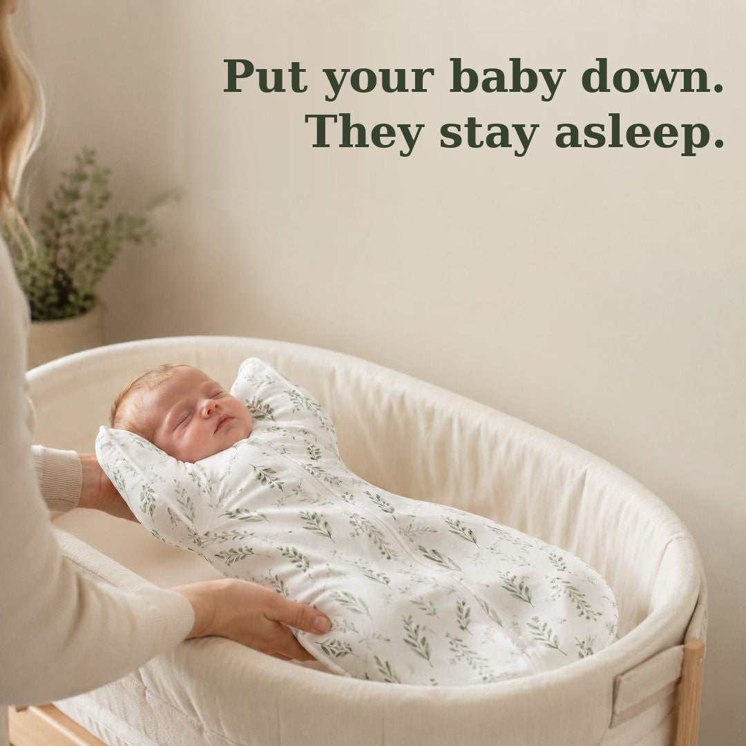 Parent lowering a sleeping baby in the CradleUp arms-up swaddle into a bassinet — put your baby down and they stay asleep