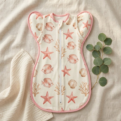 CradleUp swaddle flat lay, Underwater World print with pink binding
